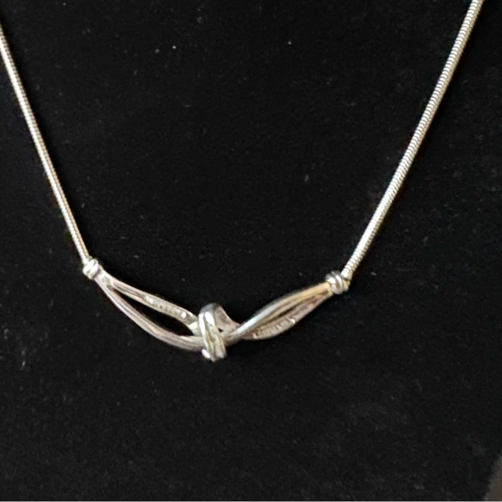 Sterling Silver and Diamond Knot Pendant with Baguette Diamonds. Marked HN 925